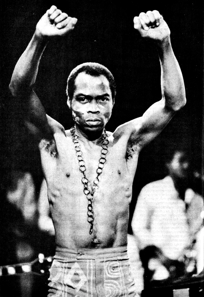 Fela Kuti on stage with both fists raised