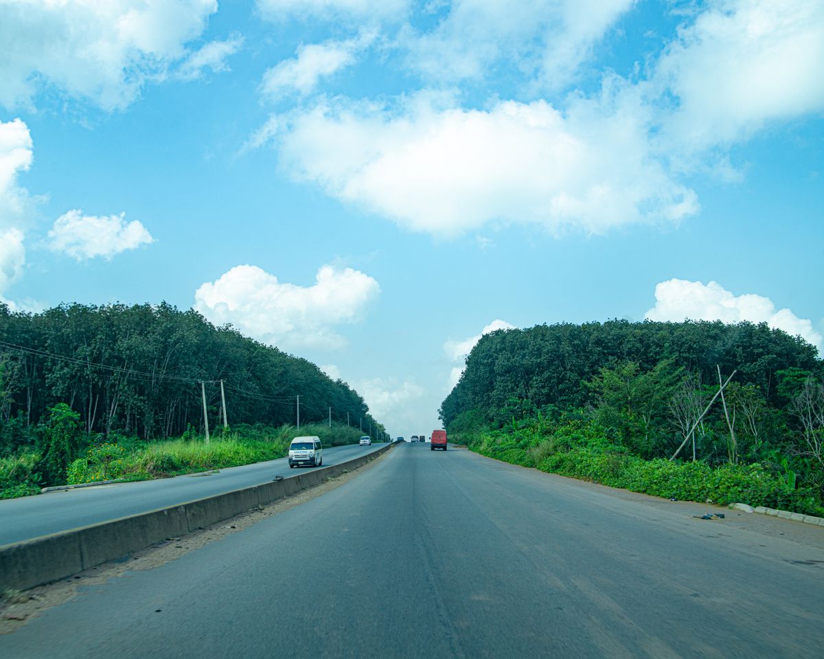 An open highway through greenery in Nigeria